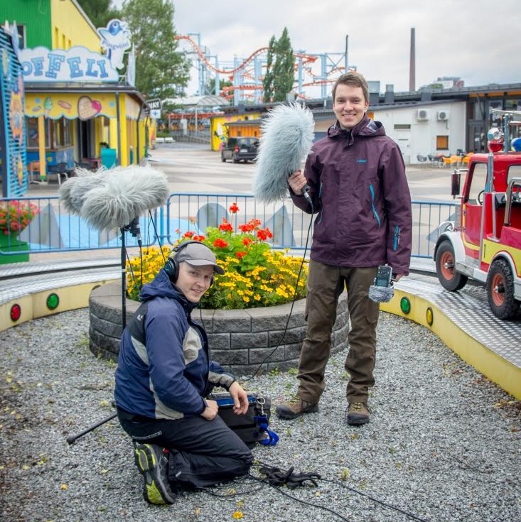 Two men pose with their recording equipment