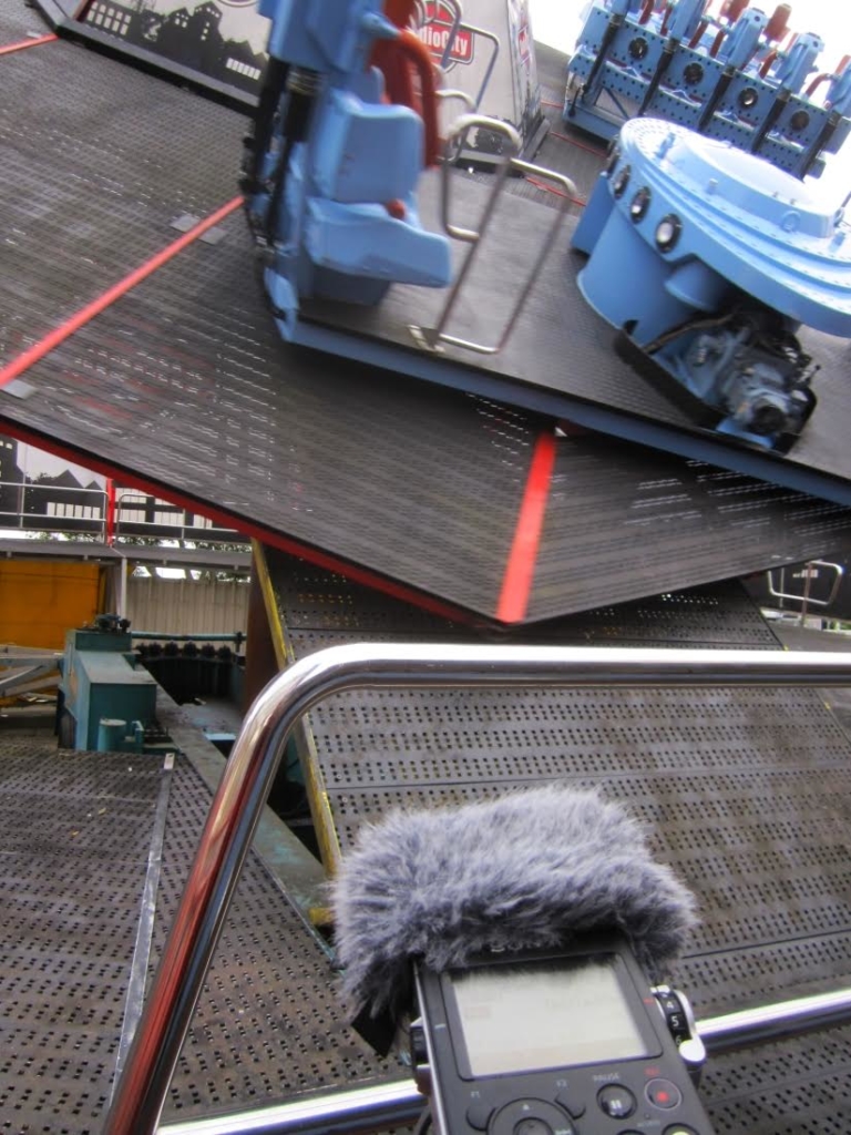 A digital recorder faces an empty spinning ride