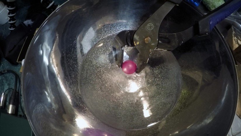 pliers holding a ball bearing