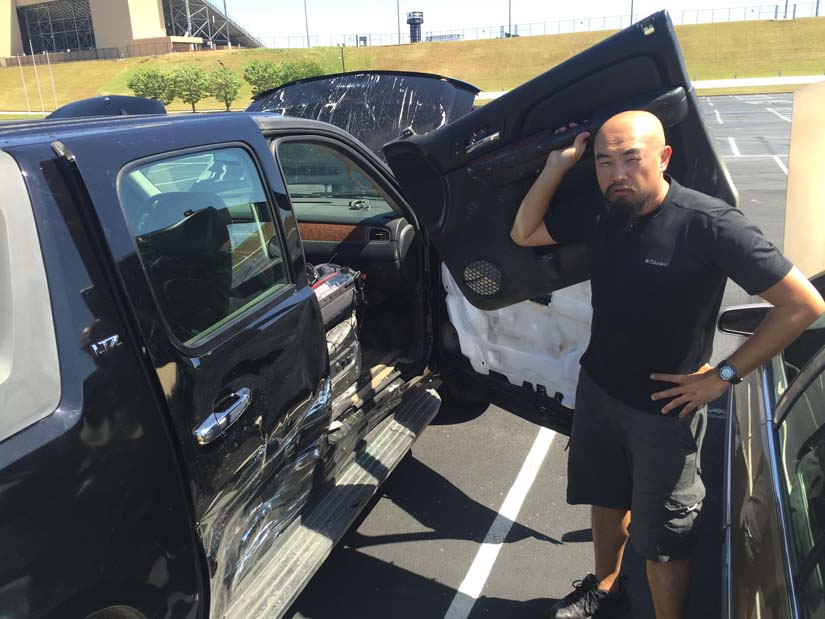 Watson Wu holds the door to the damaged Avalanche