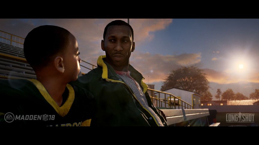 A young Devin Wade talks to his father as they sit on the benches.