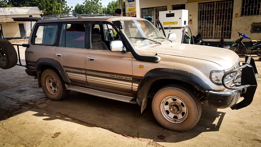An all terrain vehicle stops at a gas pump.