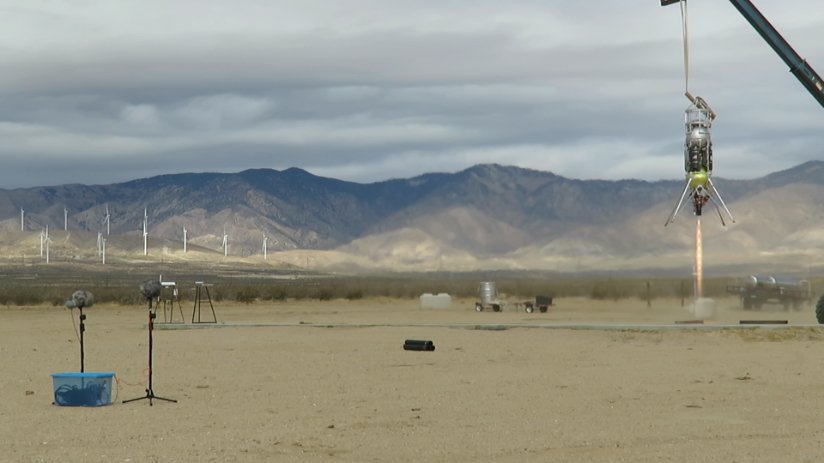 Two boom mics record the Lunar Lander as it sprays hot flames towards the Earth.