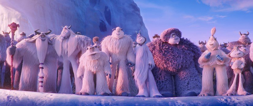 Yetis of all shapes and sizes stand together.