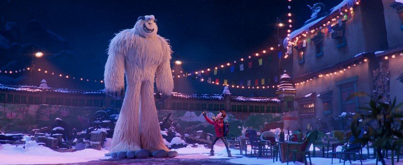 The yeti and a boy play in a snowy human town.