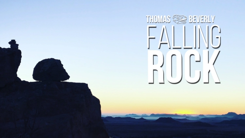 A large boulder sits on the side of a cliff with the title Falling Rock