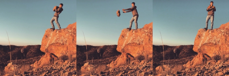 A man throws large heavy rocks off a platform in the Southwest
