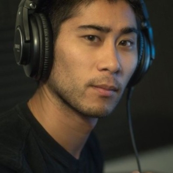 A man in a black shirt wearing headphones