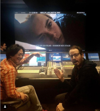 Two men at a soundboard.